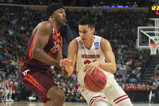 Wisconsin guard Bronson Koenig (24) drives to the basket against Virginia Tech forward Zach LeDay (32) during the first half of a first-round men's college basketball game in the NCAA Tournament, Thursday, March 16, 2017, in Buffalo, N.Y. (AP Photo/Bill Wippert)