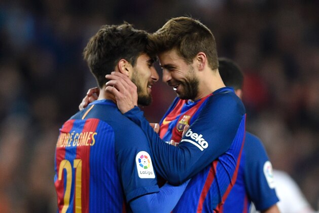 Barcelona's Portuguese midfielder Andre Gomes (L) celebrates with Barcelona's defender Gerard Pique (R) after scoring a goal during the Spanish league football match FC Barcelona vs Valencia CF at the Camp Nou stadium in Barcelona on March 19, 2017. / AFP PHOTO / LLUIS GENE (Photo credit should read LLUIS GENE/AFP/Getty Images) Barcelona's Portuguese midfielder Andre Gomes (L) celebrates with Barcelona's defender Gerard Pique (R) after scoring a goal during the Spanish league football match FC Barcelona vs Valencia CF at the Camp Nou stadium in Barcelona on March 19, 2017. / AFP PHOTO / LLUIS GENE (Photo credit should read LLUIS GENE/AFP/Getty Images)