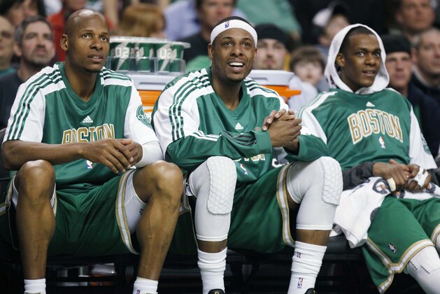 Boston Celtics players, from left, Ray Allen, Paul Pierce and Rajon Rondo watch from the bench in the fourth quarter of an NBA basketball game against the Milwaukee Bucks, Sunday, March 13, 2011, in Boston.  Ray Allen scored 17 points in just three quarters and the Boston Celtics set a franchise record for fewest points allowed in the shot clock era, routing the Milwaukee Bucks 87-56.  (AP Photo/Michael Dwyer)