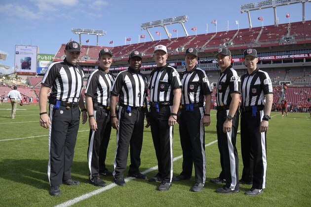 Field judge Brad Freeman (88), back judge Jim Quirk (63), umpire Roy Ellison (81), referee Carl Cheffers (51), head linesman Kent Payne (79), line judge Tim Podraza (47) and side judge Scott Novak (1) pose before an NFL football game between the Tampa Bay Buccaneers and the Carolina Panthers in Tampa, Fla., Sunday, Jan. 1, 2017. (AP Photo/Phelan M. Ebenhack)