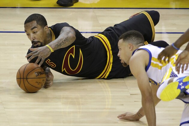 Cleveland Cavaliers guard J.R. Smith (5) reaches for the ball in front of Golden State Warriors guard Stephen Curry during the first half of Game 5 of basketball's NBA Finals in Oakland, Calif., Monday, June 13, 2016. (AP Photo/Eric Risberg)