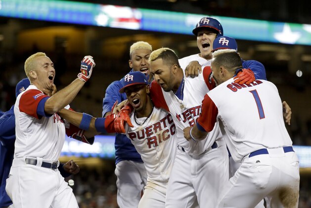 Puerto Rico team members celebrate their win over the Netherlands in a semifinal in the World Baseball Classic in Los Angeles, Monday, March 20, 2017. (AP Photo/Chris Carlson)
