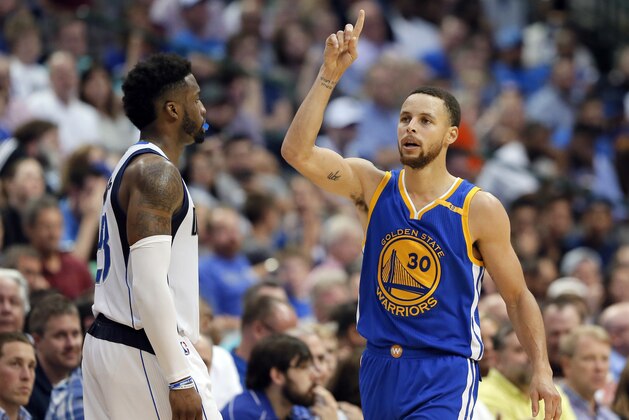Dallas Mavericks guard Wesley Matthews (23) watches as Golden State Warriors' Stephen Curry (30) celebrates sinking a 3-point basket in the second half of an NBA basketball game, Tuesday, March 21, 2017, in Dallas. (AP Photo/Tony Gutierrez)