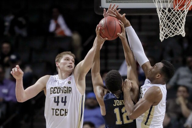 Georgia Tech center Ben Lammers (44) and guard Josh Okogie (5) block a shot attempt by Pittsburgh guard Chris Jones (12) during the second half of an NCAA college basketball game in the first round of the ACC tournament, Tuesday, March 7, 2017, in New York. Pittsburgh won 61-59. (AP Photo/Julie Jacobson)