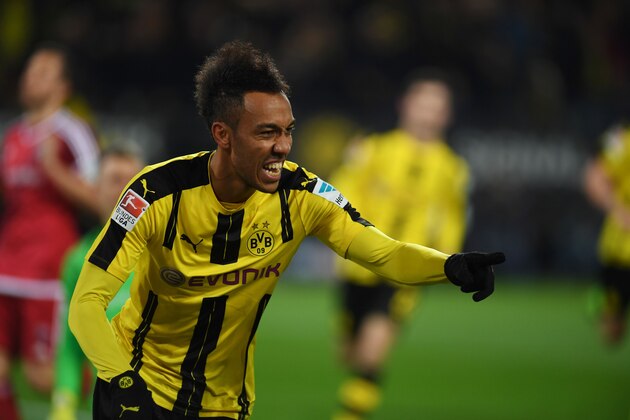 Dortmund's Gabonese forward Pierre-Emerick Aubameyang celebrates scoring the opening goal with his teammates during the German First division Bundesliga football match BVB Borussia Dortmund vs FC Ingolstadt in Dortmund, western Germany on March 17, 2017. / AFP PHOTO / PATRIK STOLLARZ / RESTRICTIONS: DURING MATCH TIME: DFL RULES TO LIMIT THE ONLINE USAGE TO 15 PICTURES PER MATCH AND FORBID IMAGE SEQUENCES TO SIMULATE VIDEO. == RESTRICTED TO EDITORIAL USE == FOR FURTHER QUERIES PLEASE CONTACT DFL DIRECTLY AT + 49 69 650050
        (Photo credit should read PATRIK STOLLARZ/AFP/Getty Images)