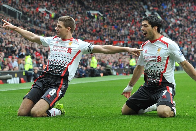 Liverpool's English midfielder Steven Gerrard (L) celebrates with Liverpool's Uruguayan forward Luis Suarez after scoring his team's second goal during the English Premier League football match between Manchester United and Liverpool at Old Trafford in Manchester, Northwest England, on March 16, 2014. AFP PHOTO/PAUL ELLIS

RESTRICTED TO EDITORIAL USE. NO USE WITH UNAUTHORIZED AUDIO, VIDEO, DATA, FIXTURE LISTS, CLUB/LEAGUE LOGOS OR LIVE SERVICES. ONLINE IN-MATCH USE LIMITED TO 45 IMAGES, NO VIDEO EMULATION. NO USE IN BETTING, GAMES OR SINGLE CLUB/LEAGUE/PLAYER PUBLICATIONS.        (Photo credit should read PAUL ELLIS/AFP/Getty Images)