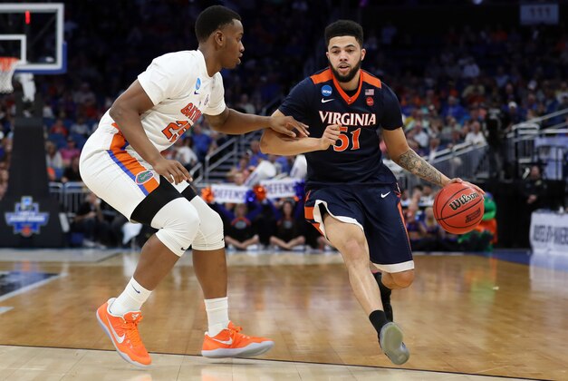 Mar 18, 2017; Orlando, FL, USA; Virginia Cavaliers guard Darius Thompson (51) drives against Florida Gators forward Keith Stone (25) during the second half in the second round of the 2017 NCAA Tournament at Amway Center. Mandatory Credit: Logan Bowles-USA TODAY Sports