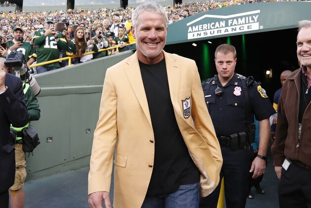 Former Green Bay Packers' Brett Favre smiles as he arrives for a halftime ceremony of an NFL football game against the Dallas Cowboys Sunday, Oct. 16, 2016, in Green Bay, Wis. (AP Photo/Matt Ludtke)
