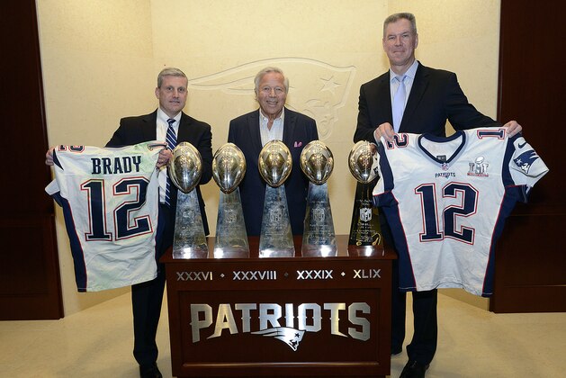 In this photo released by the Federal Bureau of Investigation, Harold H. Shaw, left, Special Agent in Charge of the FBI Boston Division and Colonel Richard D. McKeon, right, of the Massachusetts State Police, hold two recovered Super Bowl jerseys worn by New England Patriots quarterback Tom Brady, beside team owner Robert Kraft, center, on Thursday, March 23, 2017 in the NFL football team's trophy room at Gillette Stadium in Foxborough, Mass. Brady's jersey went missing from the Patriots' locker room after their Super Bowl win over the Atlanta Falcons on Feb. 5, setting off an investigation that stretched from Boston to the Mexican border. (FBI via AP)