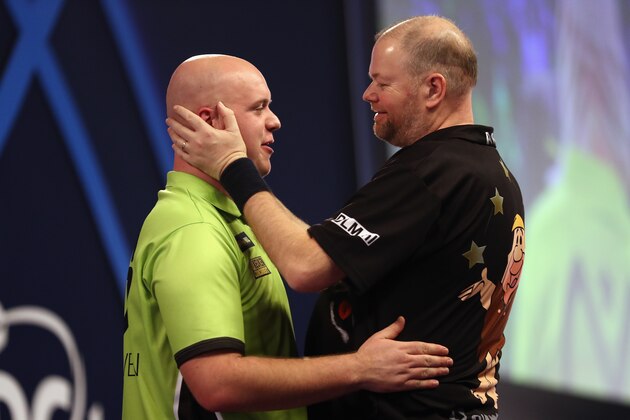 LONDON, ENGLAND - JANUARY 01:  Raymond van Barneveld (r) of The Netherlands congratulates Michael van Gerwen of The Netherlands on winning their semi-final match on day fourteen of the 2017 William Hill PDC World Darts Championships at Alexandra Palace on January 1, 2017 in London, England.  (Photo by Bryn Lennon/Getty Images)