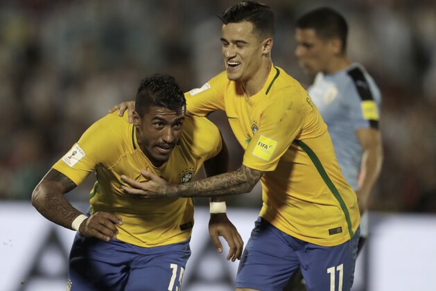 Brazil's Paulinho, left, is congratulated by teammate Brazil's P. Coutinho, after he scored against Uruguay during a 2018 World Cup qualifying soccer match in Montevideo, Uruguay, Thursday, March. 23, 2017. (AP Photo/Natacha Pisarenko)
