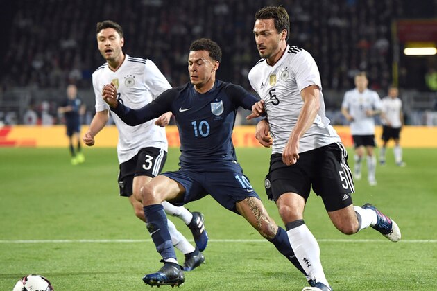 Germany's Jonas Hector, left, looks on as England's Dele Alli, center, and Germany's Mats Hummels, right, challenge for the ball during the friendly soccer match between Germany and England in Dortmund, Germany, Wednesday, March 22, 2017. (AP Photo/Martin Meissner)
