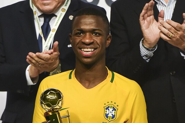 Brazil´s  Vinicius Junior poses with the best player trophy in the South American U-17 football tournament in Rancagua, some 90 km south of Santiago de Chile on March 19, 2017. / AFP PHOTO / MARTIN BERNETTI        (Photo credit should read MARTIN BERNETTI/AFP/Getty Images)
