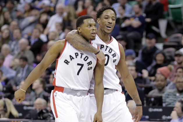 Toronto Raptors' Kyle Lowry (7) celebrates with teammate DeMar DeRozan (10) after scoring in the second half during an NBA basketball game against the Utah Jazz Friday, Dec. 23, 2016, in Salt Lake City. The Raptors won 104-98. (AP Photo/Rick Bowmer)