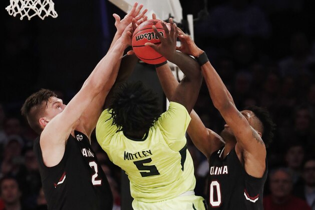 Baylor forward Johnathan Motley (5) goes up for a shot against South Carolina forward Maik Kotsar (21) and forward Chris Silva (30) in the first half of an East Regional semifinal game of the NCAA men's college basketball tournament, Friday, March 24, 2017, in New York. (AP Photo/Julio Cortez)