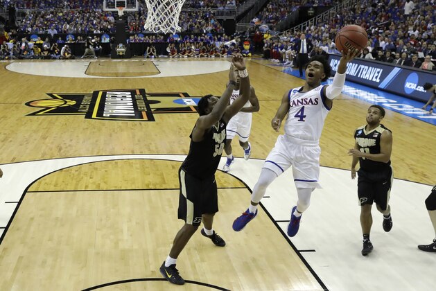 Kansas guard Devonte' Graham (4) drives to the basket past Purdue forward Caleb Swanigan (50) during the first half of a regional semifinal of the NCAA men's college basketball tournament, Thursday, March 23, 2017, in Kansas City, Mo. (AP Photo/Charlie Riedel)