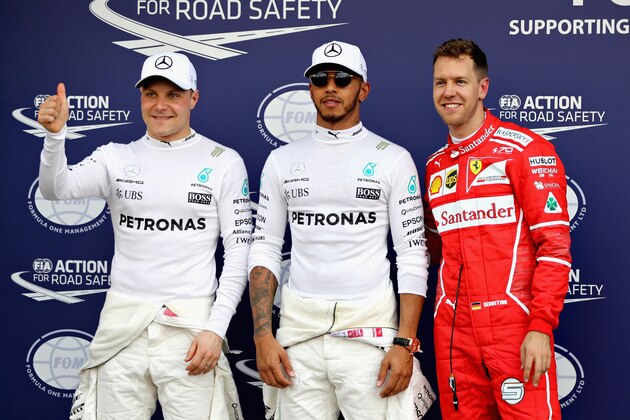 MELBOURNE, AUSTRALIA - MARCH 25: Top three qualifiers Lewis Hamilton of Great Britain and Mercedes GP, Sebastian Vettel of Germany and Ferrari and Valtteri Bottas of Finland and Mercedes GP pose for a photo in parc ferme  during qualifying for the Australian Formula One Grand Prix at Albert Park on March 25, 2017 in Melbourne, Australia.  (Photo by Mark Thompson/Getty Images)