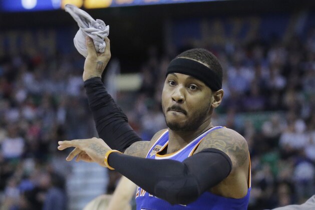 New York Knicks forward Carmelo Anthony (7) throws a t-shirt to the sidelines before the start of their NBA basketball game against the Utah Jazz Wednesday, March 22, 2017, in Salt Lake City. (AP Photo/Rick Bowmer)