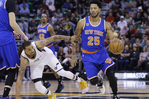 New York Knicks guard Derrick Rose (25) drives around Utah Jazz guard George Hill, left, during the first half during an NBA basketball game Wednesday, March 22, 2017, in Salt Lake City. (AP Photo/Rick Bowmer)