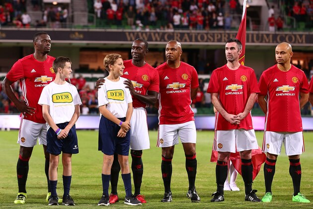 PERTH, AUSTRALIA - MARCH 25: Louis Saha, Dwight Yorke, Quinton Fortune, Keith Gillespie and Danny Webber of the Manchester United Legends line up for the national anthems during the Manchester United Legends and the PFA Aussie Legends match at nib Stadium on March 25, 2017 in Perth, Australia.  (Photo by Paul Kane/Getty Images)