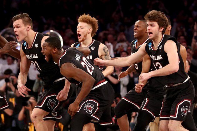 NEW YORK, NY - MARCH 26:  Maik Kotsar #21 and Justin McKie #20 of the South Carolina Gamecocks celebrate with their teammates after defeating the Florida Gators with a score of 77 to 70 to win the 2017 NCAA Men's Basketball Tournament East Regional at Madison Square Garden on March 26, 2017 in New York City.  (Photo by Maddie Meyer/Getty Images)