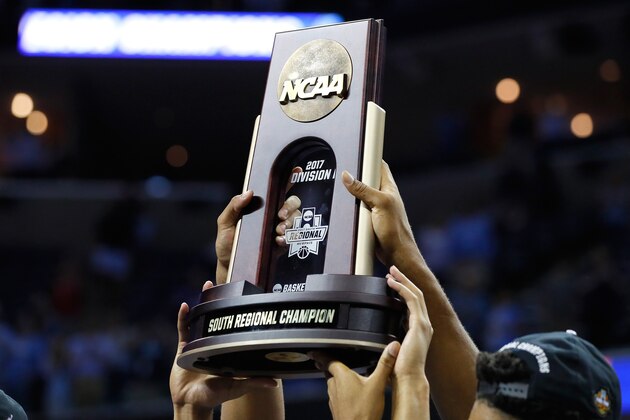 MEMPHIS, TN - MARCH 26: The North Carolina Tar Heels hold up the South Regional Champion trophy after defeating the Kentucky Wildcats during the 2017 NCAA Men's Basketball Tournament South Regional at FedExForum on March 26, 2017 in Memphis, Tennessee.  (Photo by Kevin C. Cox/Getty Images)