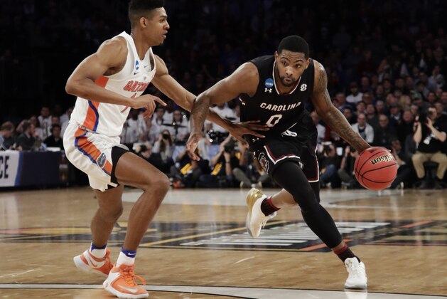 South Carolina guard Sindarius Thornwell (0) drives the ball against Florida forward Devin Robinson (1) during the first half of the East Regional championship game of the NCAA men's college basketball tournament, Sunday, March 26, 2017, in New York. (AP Photo/Frank Franklin II)