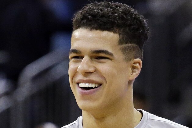 In this photo taken Feb. 8, 2017, Michael Porter Jr., the nation's No. 1 high school recruit for the nation's No. 1 high school team, Nathan Hale High School, smiles before a Metro League basketball game, in Seattle. The idea that Porter will play for Washington next season assumes that Huskies head coach Lorenzo Romar is back next season as well. But Romar's team is headed toward likely their worst season of the his 15-year tenure and a sixth straight season of missing the NCAA tournament. (AP Photo/Elaine Thompson)