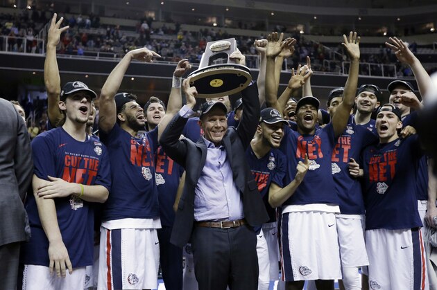 Gonzaga head coach Mark Few, center, holds a trophy as his players surround him after a win over Xavier in an NCAA Tournament college basketball regional final game Saturday, March 25, 2017, in San Jose, Calif. (AP Photo/Ben Margot)