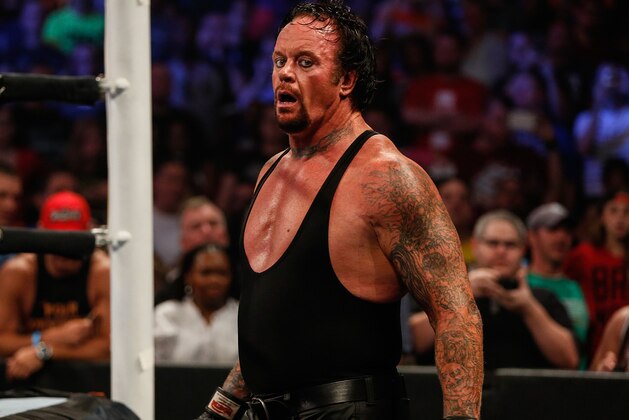NEW YORK, NY - AUGUST 23: The Undertaker recovers during his fight against Brock Lesner at the WWE SummerSlam 2015 at Barclays Center of Brooklyn on August 23, 2015 in New York City.  (Photo by JP Yim/Getty Images)