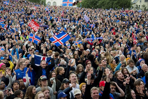 Fans of Iceland celebrate at a public screening of the UEFA Euro 2016 Round of 16 football match England v Iceland, taking place in France, on June 27, 2016 in Reykjavik, Iceland. / AFP / HALLDOR KOLBEINS        (Photo credit should read HALLDOR KOLBEINS/AFP/Getty Images)