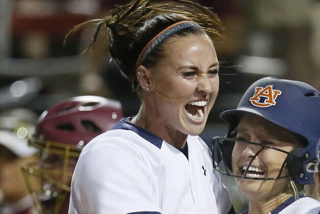 FILE - In this June 5, 2016, file photo, Auburn infielder Haley Fagan, left, and outfielder Morgan Podany celebrate Podany's game winning run against Florida State in the eighth inning of an NCAA Women's College World Series softball game in Oklahoma City. Florida softball coach Tim Walton was involved in an altercation with Auburn shortstop Haley Fagan on Monday night, March 27, 2017, after Walton gave Fagan a slight push during postgame handshakes. (AP Photo/Sue Ogrocki, File)