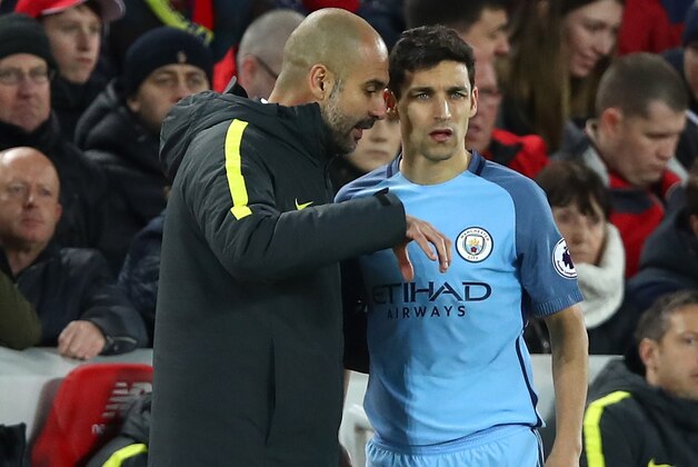 LIVERPOOL, ENGLAND - DECEMBER 31:  Jesus Navas of Manchester City speaks with Josep Guardiola, Manager of Manchester City during the Premier League match between Liverpool and Manchester City at Anfield on December 31, 2016 in Liverpool, England.  (Photo by Clive Brunskill/Getty Images)