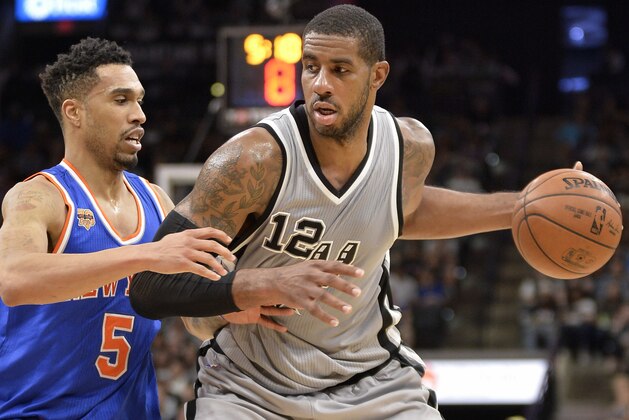 San Antonio Spurs forward LaMarcus Aldridge (12) drives against New York Knicks guard Courtney Lee during the second half of an NBA basketball game, Saturday, March 25, 2017, in San Antonio. (AP Photo/Darren Abate)