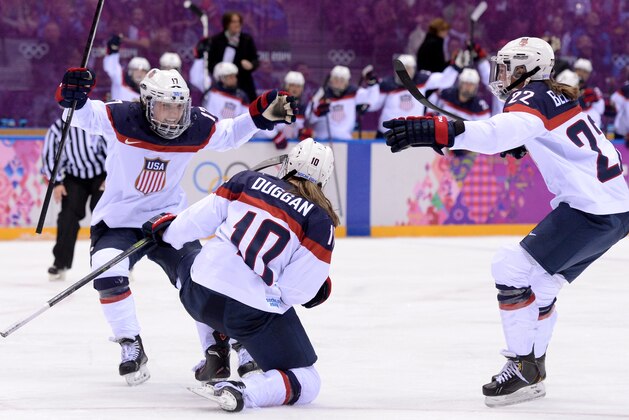 US Meghan Duggan (C) celebrates with US Jocelyne Lamoureux and US Kacey Bellamy after scoring during the Women's Ice Hockey Gold Medal Game between Canada and USA at the Bolshoy Ice Dome during the Sochi Winter Olympics on February 20, 2014.      AFP PHOTO / ANDREJ ISAKOVIC        (Photo credit should read ANDREJ ISAKOVIC/AFP/Getty Images)