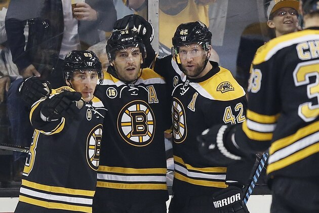Boston Bruins' Patrice Bergeron (37) celebrates his goal with teammates Brad Marchand (63) and David Backes (42) during the first period of an NHL hockey game against the Nashville Predators in Boston, Tuesday, March 28, 2017. The Bruins on 4-1. (AP Photo/Michael Dwyer)