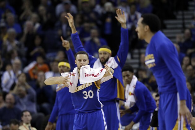 Golden State Warriors' Stephen Curry (30) celebrates from the bench during the first half of an NBA basketball game against the Memphis Grizzlies Sunday, March 26, 2017, in Oakland, Calif. (AP Photo/Marcio Jose Sanchez)