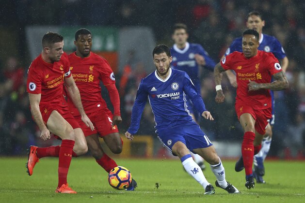 Liverpool's Jordan Henderson, left, challenges for the ball with Chelsea's Eden Hazard during the English Premier League soccer match between Liverpool and Chelsea at Anfield stadium in Liverpool, England, Tuesday, Jan. 31, 2017. (AP Photo/Dave Thompson)