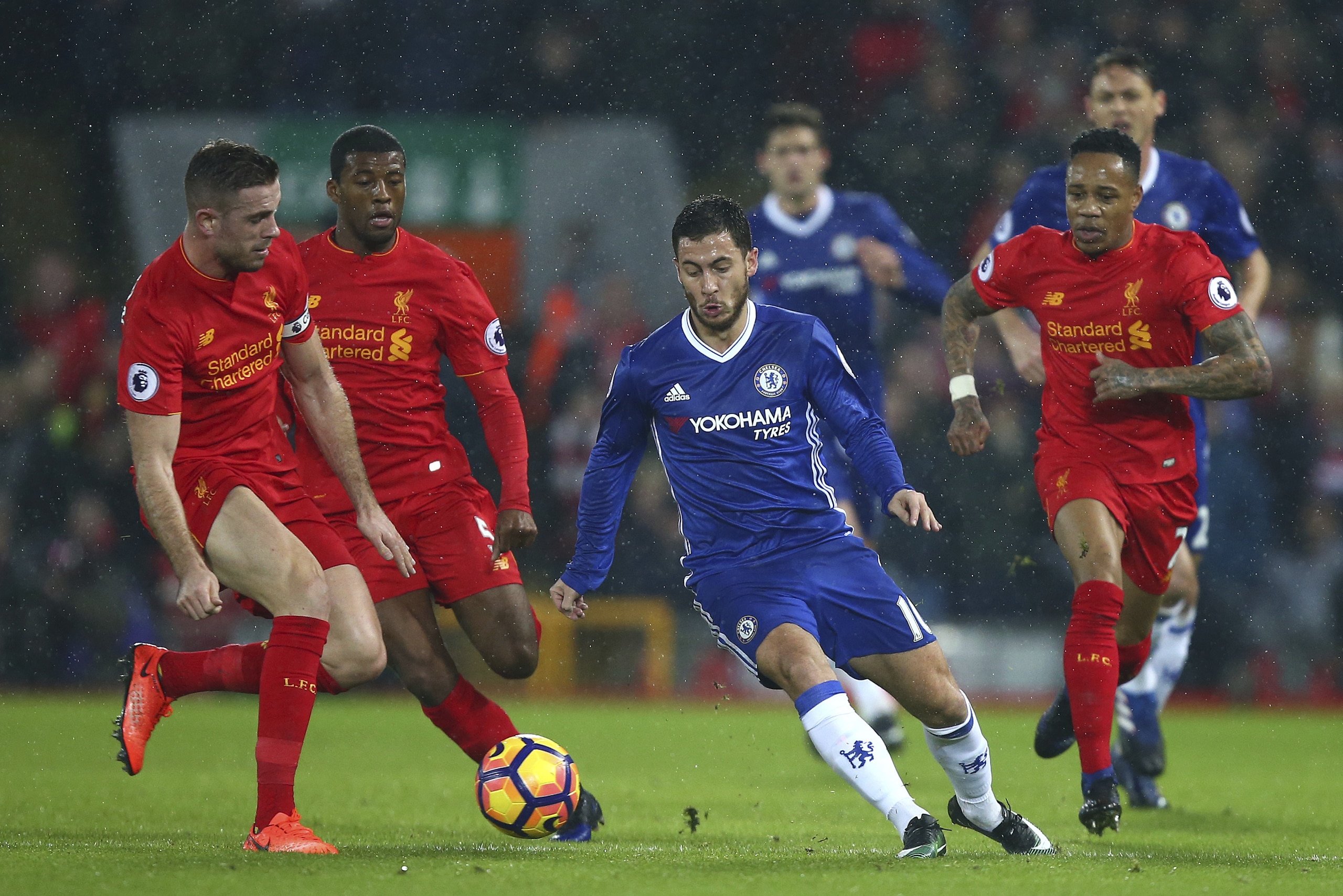 Liverpool's Jordan Henderson, left, challenges for the ball with Chelsea's Eden Hazard during the English Premier League soccer match between Liverpool and Chelsea at Anfield stadium in Liverpool, England, Tuesday, Jan. 31, 2017. (AP Photo/Dave Thompson)
