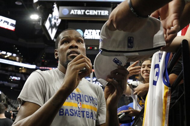 SAN ANTONIO,TX - MARCH 29: Kevin Durant #35 of the Golden State Warriors signs autographs before the start of his team's game against the San Antonio Spurs at AT&T Center on March 29, 2017 in San Antonio, Texas.   Durant is still out of action. NOTE TO USER: User expressly acknowledges and agrees that , by downloading and or using this photograph, User is consenting to the terms and conditions of the Getty Images License Agreement. (Photo by Ronald Cortes/Getty Images)