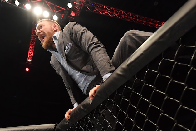 BELFAST, NORTHERN IRELAND - NOVEMBER 19:  UFC lightweight and featherweight champion Conor McGregor climbs into the Octagon to celebrate with teammate Artem Lobov after his featherweight bout against Teruto Ishihara during the UFC Fight Night at the SSE Arena on November 19, 2016 in Belfast, Northern Ireland. (Photo by Brandon Magnus/Zuffa LLC/Zuffa LLC via Getty Images)