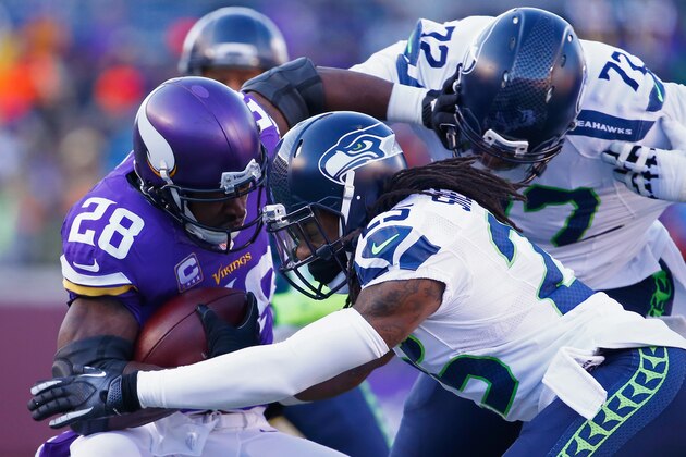 MINNEAPOLIS, MN - JANUARY 10:  Richard Sherman #25 of the Seattle Seahawks and Michael Bennett #72 attempt to tackle Adrian Peterson #28 of the Minnesota Vikings in the first quarter during the NFC Wild Card Playoff game at TCFBank Stadium on January 10, 2016 in Minneapolis, Minnesota.  (Photo by Jamie Squire/Getty Images)