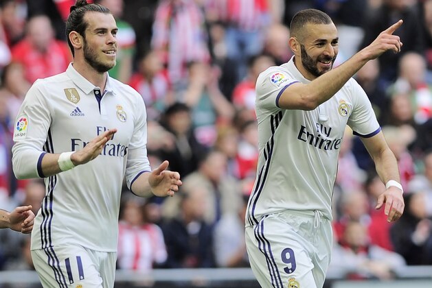 Real Madrid's French forward Karim Benzema (R) celebrates with Welsh forward Gareth Bale (L) after scoring his team's first goal during the Spanish league football match Athletic Club Bilbao vs Real Madrid CF at the San Mames stadium in Bilbao on March 18, 2017. / AFP PHOTO / ANDER GILLENEA        (Photo credit should read ANDER GILLENEA/AFP/Getty Images)