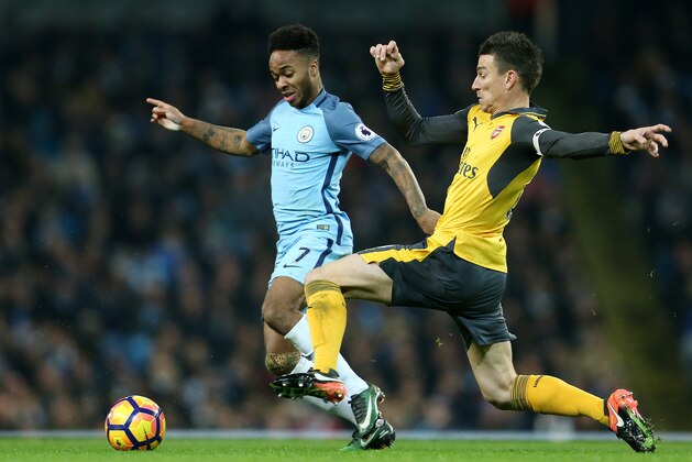 MANCHESTER, ENGLAND - DECEMBER 18: Raheem Sterling of Manchester City and Laurent Koscielny of Arsenal during the Premier League match between Manchester City and Arsenal at Etihad Stadium on December 18, 2016 in Manchester, England. (Photo by James Baylis - AMA/Getty Images)