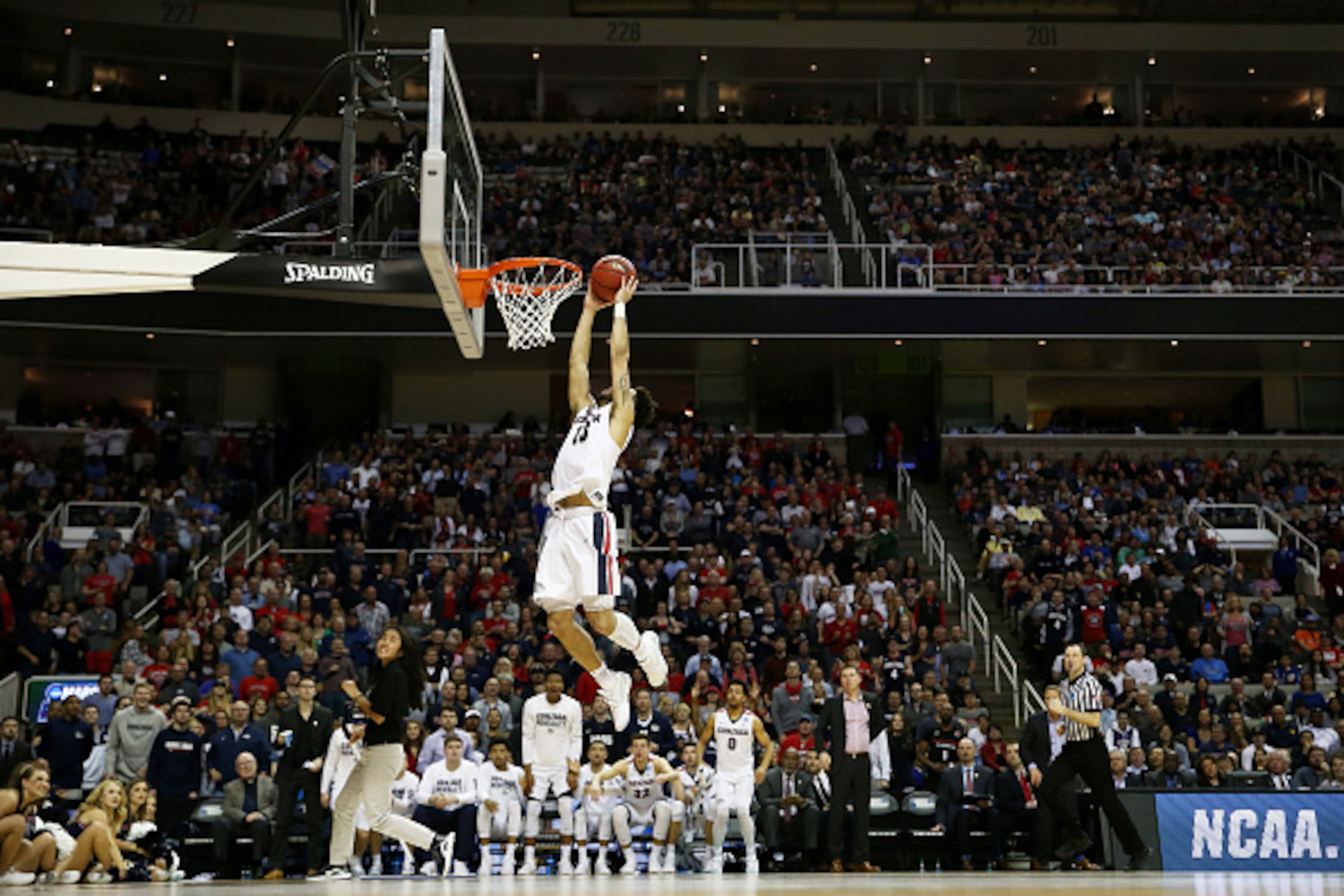 SAN JOSE, CA - MARCH 25:  Josh Perkins #13 of the Gonzaga Bulldogs drives for a dunk as a court attendent celans in the second half against the Xavier Musketeers during the 2017 NCAA Men's Basketball Tournament West Regional at SAP Center on March 25, 2017 in San Jose, California.  (Photo by Sean M. Haffey/Getty Images)