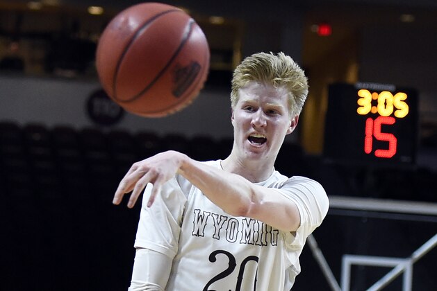 Wyoming forward Hayden Dalton passes the ball against Southern California during the second half of an NCAA college basketball game Friday, Dec. 23, 2016, in Las Vegas. Southern California won 94-92 in overtime. (AP Photo/David Becker)