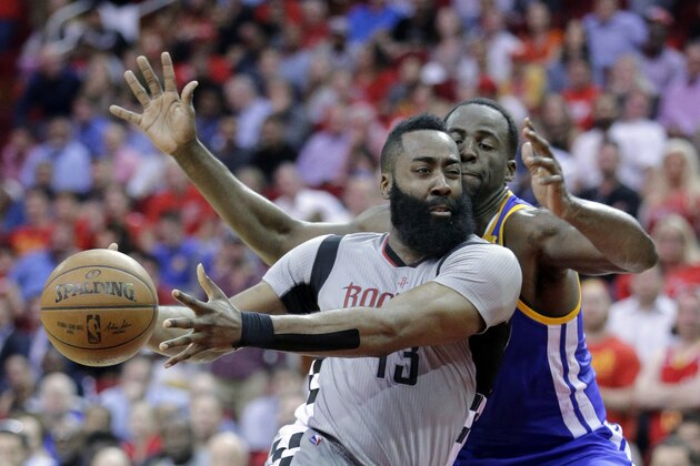Houston Rockets' James Harden (13) drives around Golden State Warriors' Draymond Green (23) in the second half of an NBA basketball game in Houston, Tuesday, March 28, 2017. (AP Photo/Michael Wyke)