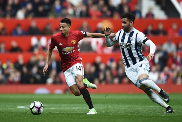 Manchester United's English midfielder Jesse Lingard (L) tries to hold off West Bromwich Albion's English-born Welsh striker Hal Robson-Kanu (R) during the English Premier League football match between Manchester United and West Bromwich Albion at Old Trafford in Manchester, north west England, on April 1, 2017. / AFP PHOTO / Oli SCARFF / RESTRICTED TO EDITORIAL USE. No use with unauthorized audio, video, data, fixture lists, club/league logos or 'live' services. Online in-match use limited to 75 images, no video emulation. No use in betting, games or single club/league/player publications.  /         (Photo credit should read OLI SCARFF/AFP/Getty Images)