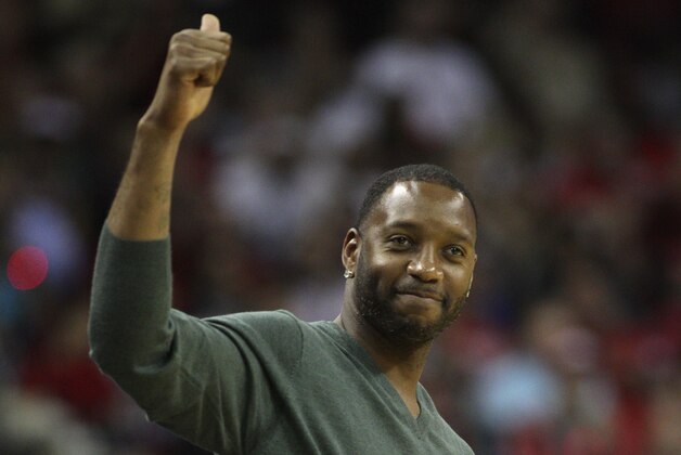 HOUSTON, TX - OCTOBER 30:  Former Houston Rocket Tracy McGrady acknowledges the crowd during a game between the Charlotte Bobcats and Houston Rockets at Toyota Center on October 30, 2013 in Houston, Texas. NOTE TO USER: User expressly acknowledges and agrees that, by downloading and or using this photograph, User is consenting to the terms and conditions of the Getty Images License Agreement.  (Photo by Bob Levey/Getty Images)