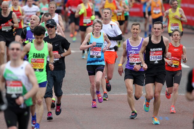 LONDON, ENGLAND - APRIL 24: Runners pass Buckingham Palace during the Virgin Money London Marathon on April 24, 2016 in London, England. (Photo by Harry Hubbard/Getty Images)